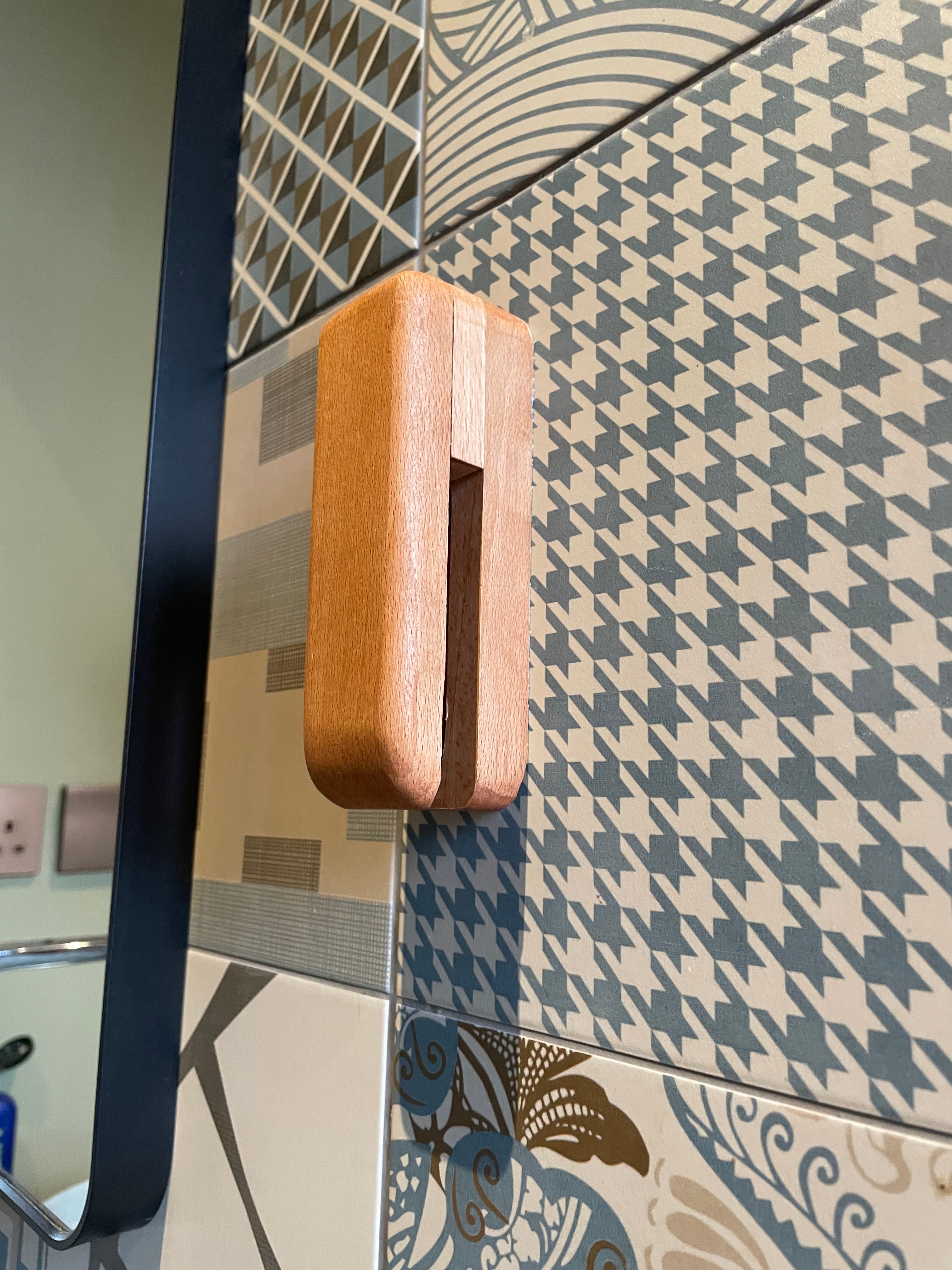 Wooden towel hook close-up on tile wall